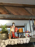 Decorative shelf arrangement with plants, a kimono-doll figurine, candles, and floral ceramics - thumbnail 2 of 5
