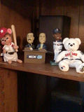 Baseball-themed stuffed animals and figurines on a shelf - thumbnail 1 of 1