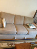 Light gray fabric sofa with two decorative pillows - thumbnail 1 of 2
