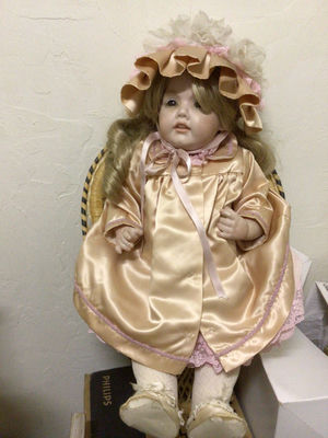 Doll in peach satin dress with bonnet - Image 1 of 1