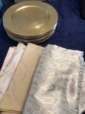 Stack of gold-toned plates with decorative patterned fabrics - thumbnail 1 of 2