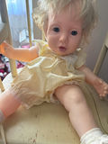 Vintage baby doll on a wooden rocking chair - thumbnail 2 of 5
