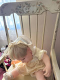 Vintage baby doll on a wooden rocking chair - thumbnail 4 of 5