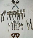 Assorted silverware set with spoons, forks, and knives - thumbnail 1 of 7