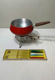 Red fondue pot on stand with burner and colored-handle skewers - thumbnail 1 of 3