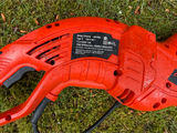 Red electric string trimmer and blue garden gnome statue - thumbnail 2 of 3