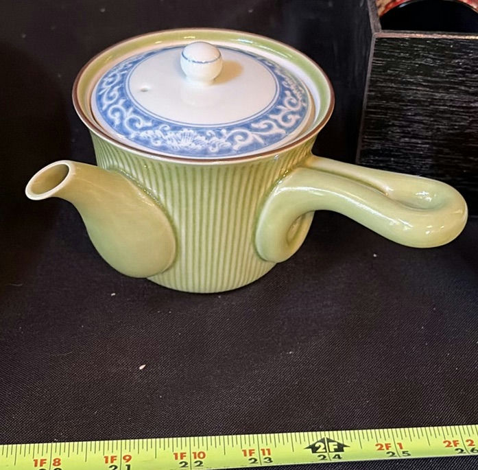 Ceramic teapot set, large glaze plate, wooden leaf vessel, and patterned fabrics - image 6 of 7