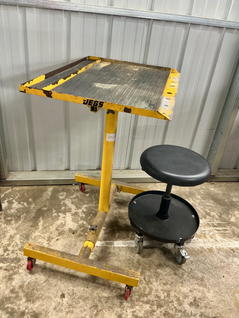 Yellow mobile work stand with ribbed tabletop and rolling stool - image 1 of 3