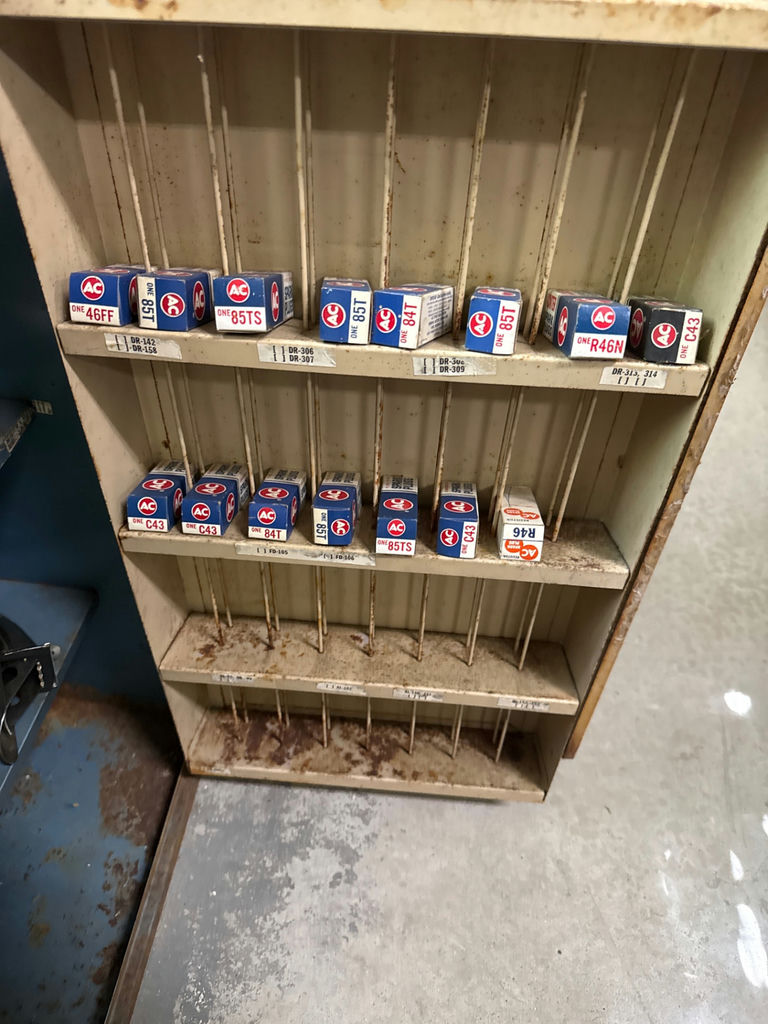Two-door cabinet with ignition decals, lubricant cans, and spark plug boxes - image 2 of 2