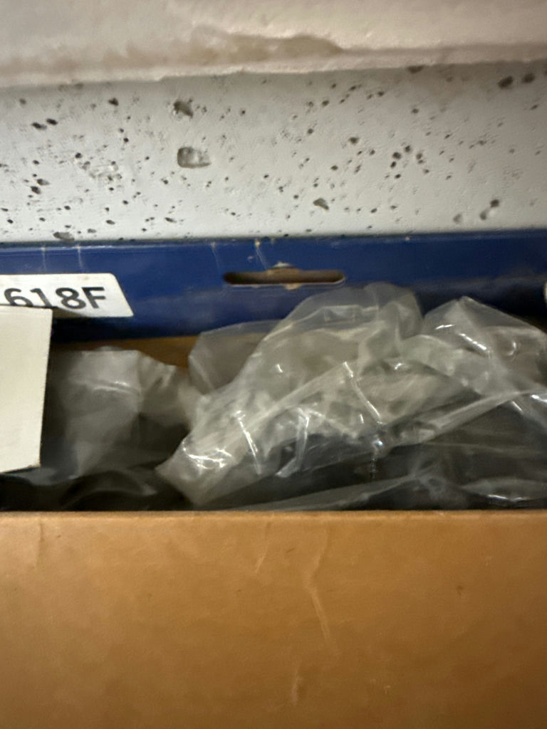 Oil filter box, spark plug wire set box, sealed beam headlight box, Chevrolet hubcap, and hammer - image 2 of 3