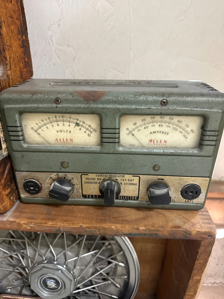 Vintage automotive parts display with Kendall oil sign and hubcaps - image 3 of 5
