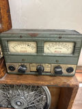 Vintage automotive parts display with Kendall oil sign and hubcaps - thumbnail 3 of 5