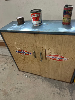 Two-door cabinet with ignition decals, lubricant cans, and spark plug boxes - Image 1 of 2