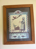 Framed folk-art print with a woman, cart and birds - thumbnail 1 of 2