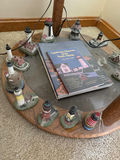 Lighthouse miniatures surrounding a book - thumbnail 1 of 3