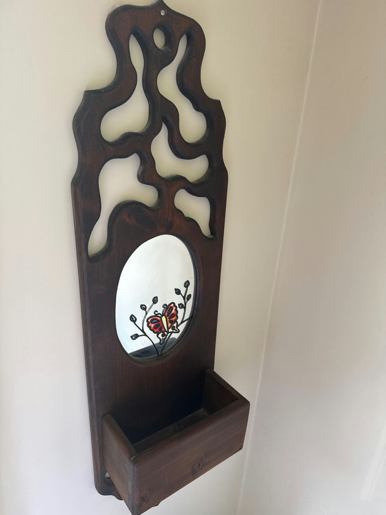 Wooden wall-mounted decorative panel with oval mirror and small shelf - image 1 of 2