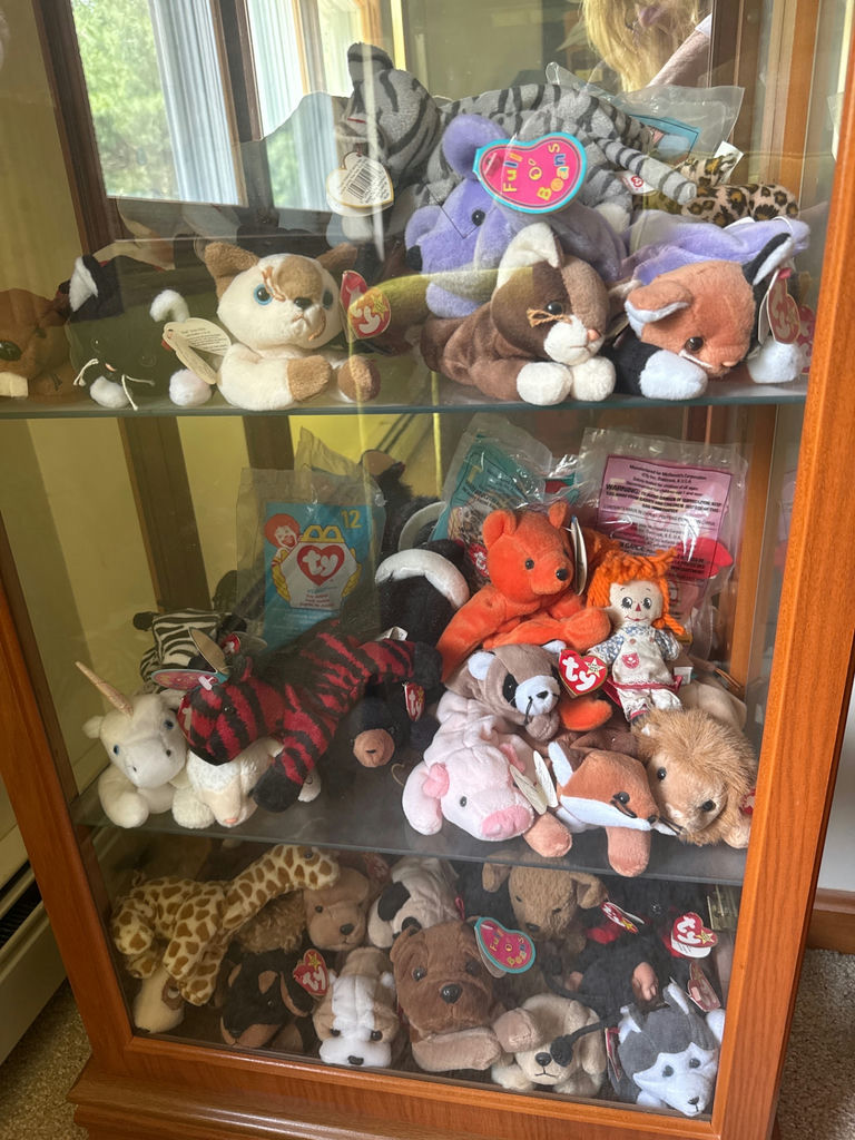 Glass display cabinet with plush stuffed animals - image 2 of 5