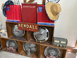 Vintage automotive parts display with Kendall oil sign and hubcaps - thumbnail 2 of 5