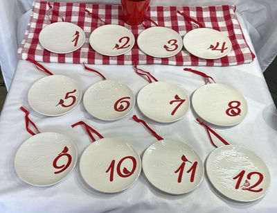 Twelve white ceramic plates with red numerals 1–12 and bird motif, each with red hanging ribbon - Image 1 of 5