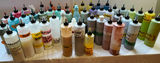 Assorted liquid paints and colorants in squeeze bottles - thumbnail 2 of 11