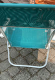Outdoor patio furniture set: turquoise mesh chairs with white frames, a white folding table, and stacked white folding chairs - thumbnail 5 of 6