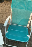 Outdoor patio furniture set: turquoise mesh chairs with white frames, a white folding table, and stacked white folding chairs - thumbnail 4 of 6