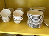 White ceramic teacups with saucers and plates - thumbnail 1 of 4