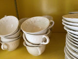 White ceramic teacups with saucers and plates - thumbnail 2 of 4