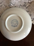 Blue-and-white Delftware plates with a porcelain figurine - thumbnail 2 of 2