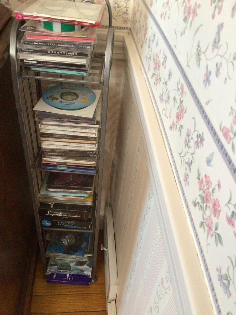 CD rack with stacked music CDs - image 1 of 5