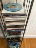 CD rack with stacked music CDs - thumbnail 3 of 5