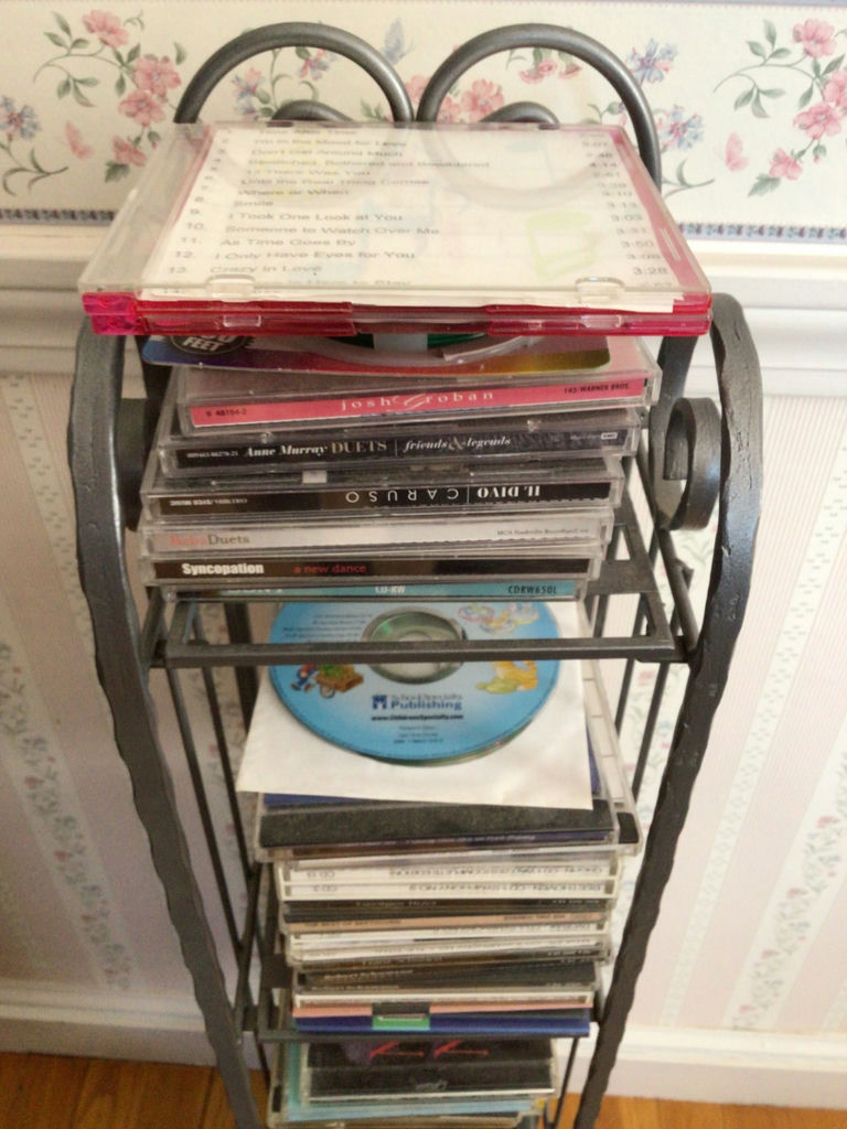 CD rack with stacked music CDs - image 2 of 5