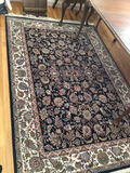 Oriental rug with black floral center and decorative border - thumbnail 1 of 4