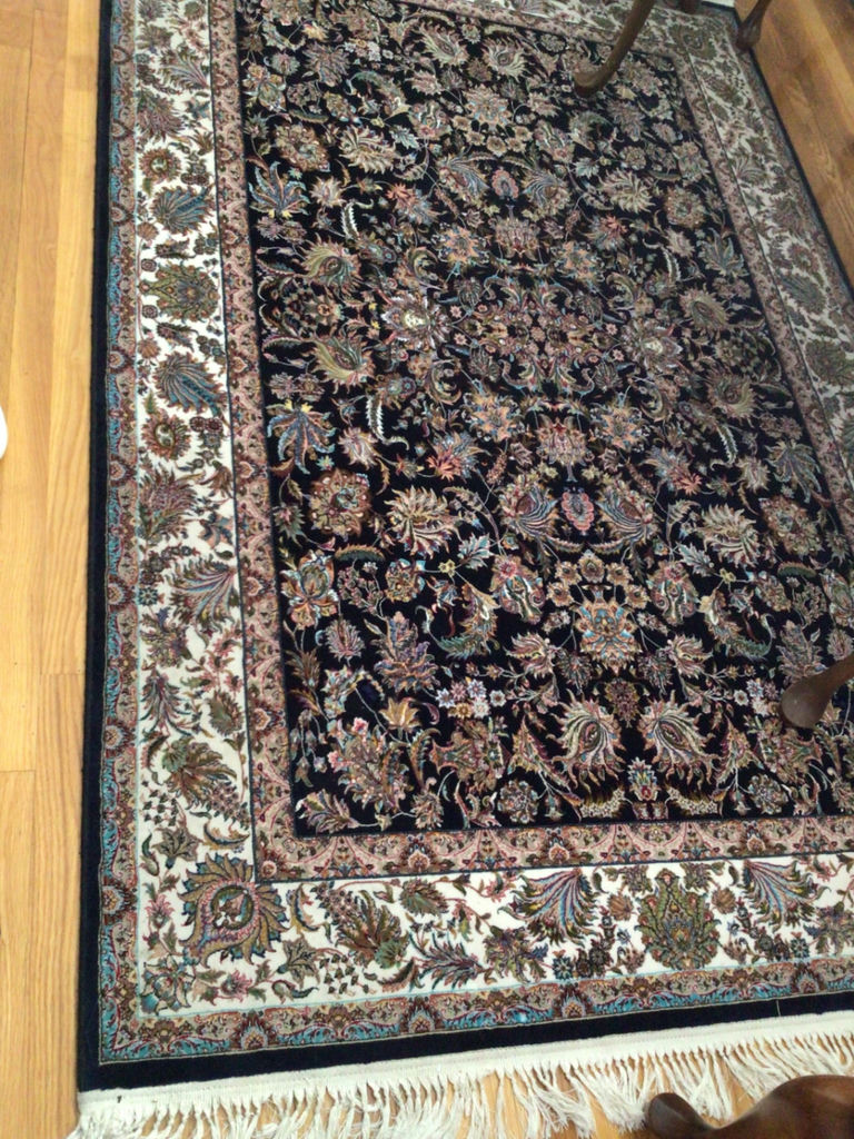 Oriental rug with black floral center and decorative border - image 2 of 4