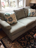 upholstered sofa with floral throw pillows - thumbnail 1 of 4