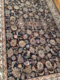 Oriental rug with black floral center and decorative border - thumbnail 3 of 4