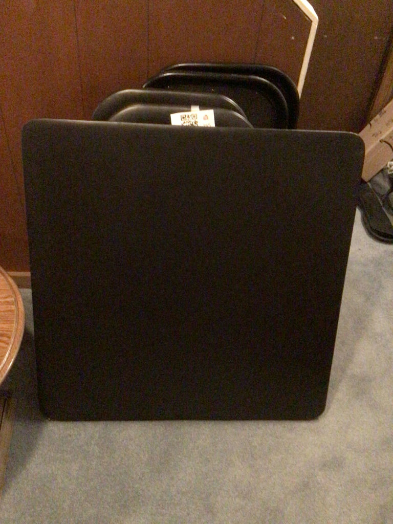 Stacked black folding chairs and card table - image 4 of 4