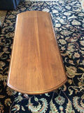Oval wooden coffee table with drop-leaf ends - thumbnail 1 of 4