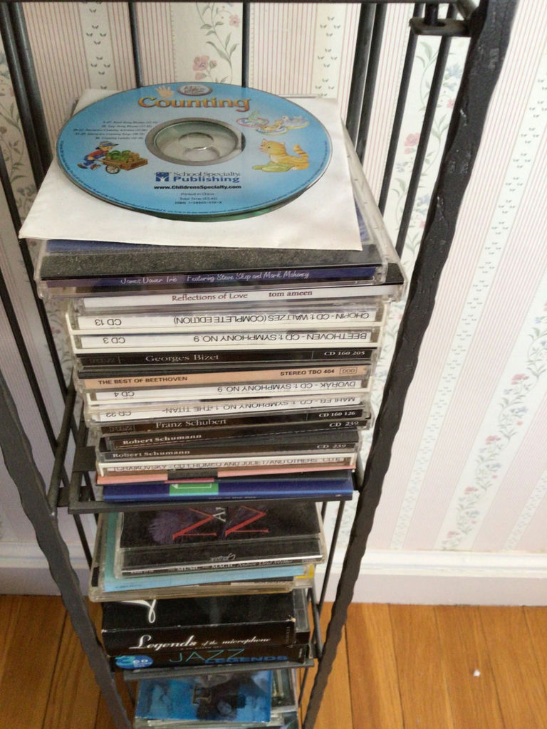 CD rack with stacked music CDs - image 4 of 5
