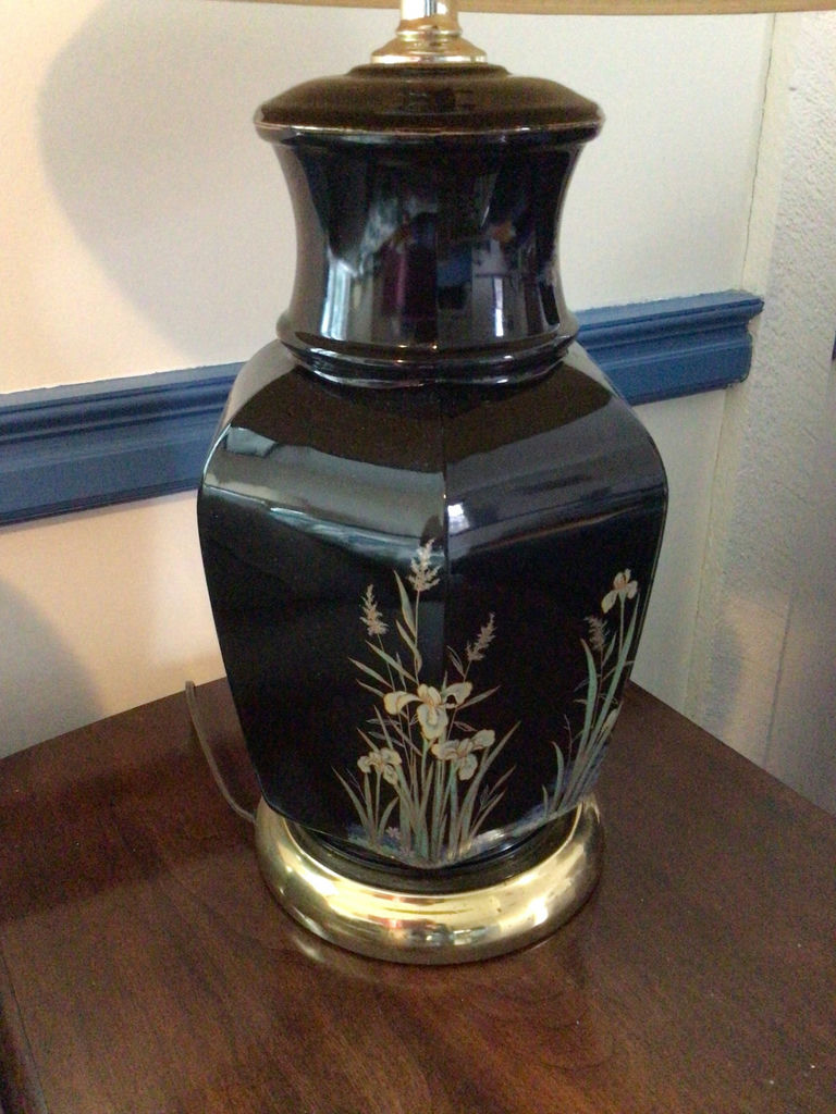 Black ceramic table lamp with floral motif and pleated shade - image 1 of 3