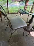 Round glass dining table with four cushioned metal chairs - thumbnail 4 of 4