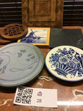 Blue-and-white plates, decorative tiles, and a wooden trivet - thumbnail 1 of 3