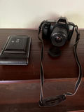 Canon EOS Rebel camera with lens and vintage Kodak camera with accessories - thumbnail 1 of 3