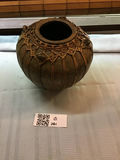 Round ceramic pot wrapped in woven rattan - thumbnail 1 of 4