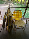Stack of folding outdoor chairs with yellow woven straps and a yellow woven chair - thumbnail 1 of 1