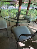 Round glass dining table with four cushioned metal chairs - thumbnail 2 of 4