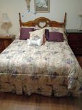 Wooden Bed Frame with Floral Bedding - thumbnail 1 of 4