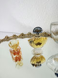 Oval gilt-mild mirror with vintage perfume bottles and decorative folding fans - thumbnail 3 of 5