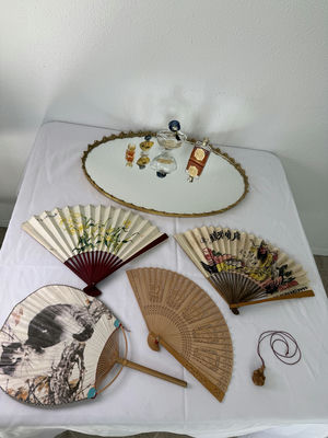 Oval gilt-mild mirror with vintage perfume bottles and decorative folding fans - Image 1 of 5