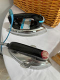 Ironing board with irons, wicker laundry basket, garment bag, and drying rack components - thumbnail 6 of 7